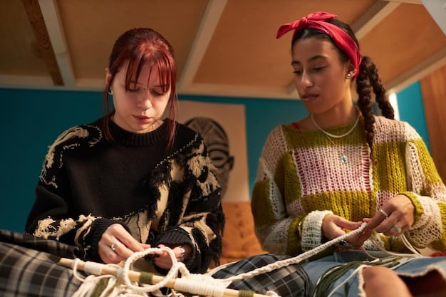 A brightly lit workshop filled with various looms and weaving tools. Two women are seated at separate looms, intently focused on weaving intricate patterns with colorful threads. Baskets of yarn and finished textiles are visible in the background, creating a sense of industry and tradition.