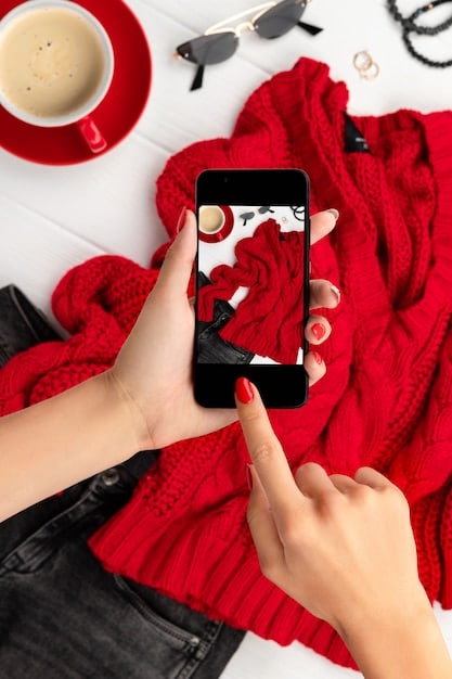 A close-up shot of a smartphone screen showing an Instagram feed filled with stylish clothing items and influencer posts in Spanish, illustrating the visual nature of fashion marketing on social media.