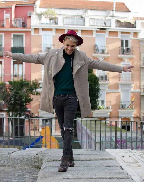 A person in Spain confidently walking in a busy street, wearing a stylish gender-neutral outfit. The photo captures the individual's self-assuredness and the acceptance of genderless fashion in the urban environment.