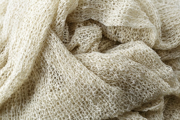 A close-up of various natural fabrics like cotton, linen, and silk, showcasing their textures and natural colors.