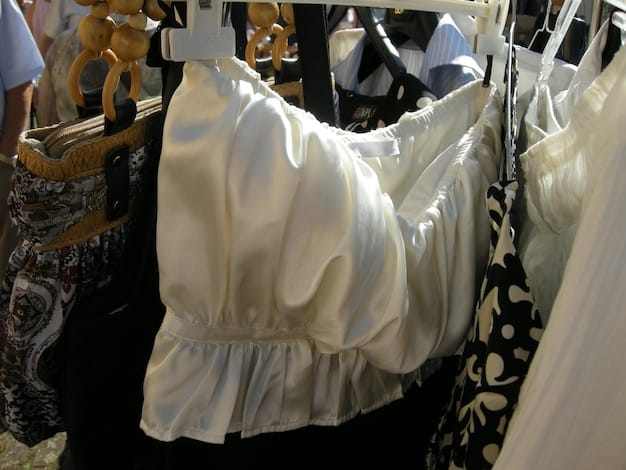 A close-up shot of a rack of designer dresses in a clothing rental store in Spain. Focus on the variety of styles, colors, and materials available for rent. Highlight the labels of well-known Spanish designers.