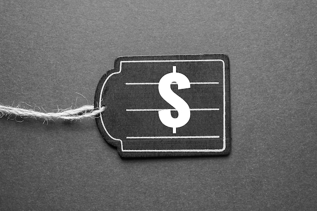 a close up of a price tag on a garment in a clothing store, with a Euro sign (€) and a percentage symbol (%) indicating the price increase due to inflation.