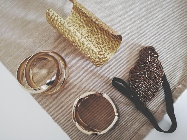 A close-up shot of various stylish accessories, including jewelry, scarves, belts, and handbags, neatly arranged on a surface. The accessories are a mix of classic and trendy pieces, showcasing versatility and style.