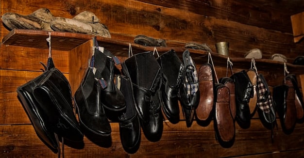 A collection of various leather shoes, including boots, loafers, and dress shoes, arranged on a wooden shelf. Each pair is in excellent condition, showcasing the different types of leather and styles