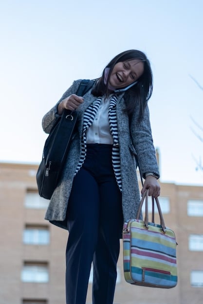 A woman on a busy city street, carrying a large, stylish tote bag filled with everyday essentials like a laptop, water bottle, and notebook, showing practicality and fashion in a single shot.