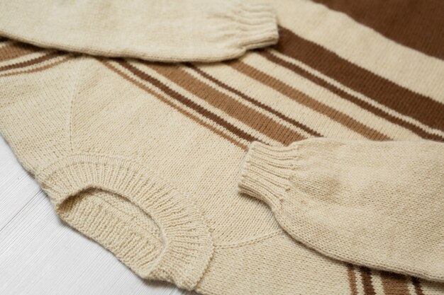 A detailed close-up of a well-organized capsule wardrobe, showcasing neutral sweaters, versatile trousers, and classic accessories. The image emphasizes the quality and coordination of the selected items, highlighting the concept of building a cohesive wardrobe.