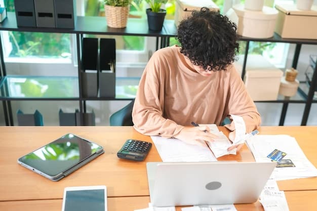 A person using a calculator and reviewing financial documents on a desk. A laptop is open in the background, displaying a government website. The lighting is soft, emphasizing the focus on financial planning and eligibility assessment for the Ingreso Mínimo Vital.