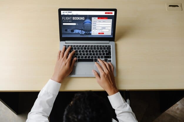 Close-up of hands typing on a laptop, filling out an online application form for rental assistance, with a focus on the digital interface.