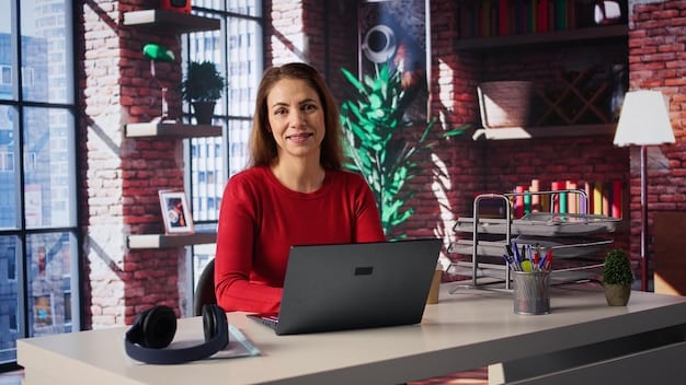 A photo of a young entrepreneur smiling while working on a laptop in a modern co-working space.