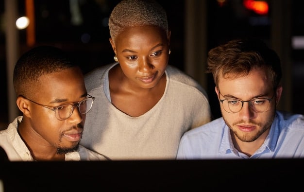 A close-up shot of a diverse team of professionals collaborating on a digital project using laptops and tablets. The focus is on the screens showing graphs, charts, and code, highlighting the technological aspect of their work. The atmosphere is collaborative and energetic, symbolizing the digital transformation process.