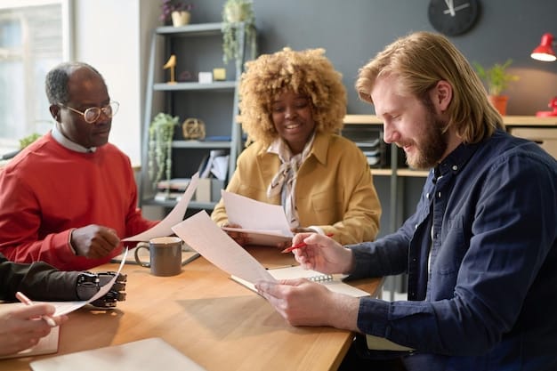 A diverse group of people gathered around a table, reviewing documents and forms related to housing assistance. The setting is a community center or government office, emphasizing accessibility and support.