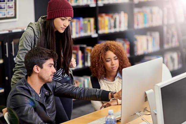 Students collaborating on a project in a modern library, using laptops and books, illustrating teamwork and the need for educational funding.